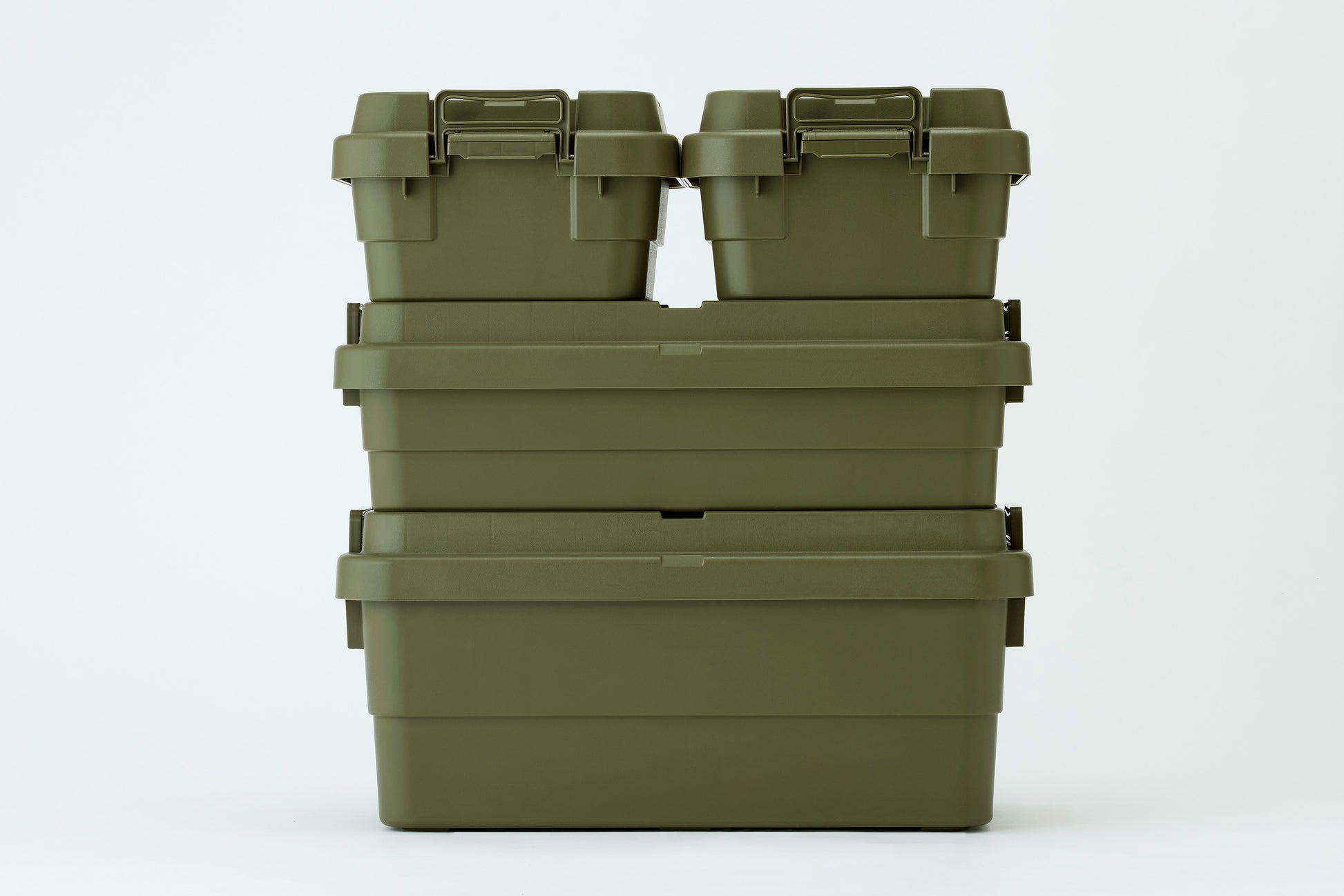 Two green TRUNK CARGO 18L Low type plastic storage boxes stacking on a green TRUNK CARGO 40L Low type plastic storage box and a green TRUNK CARGO 70L stacking type plastic storage box nicely