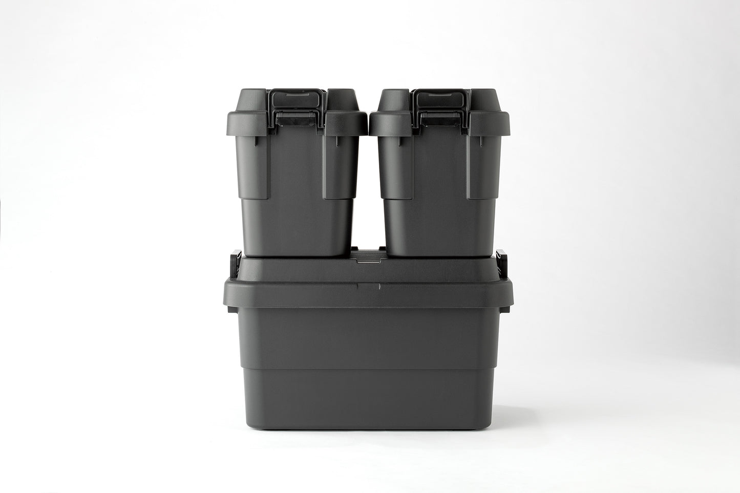 Two black TRUNK CARGO 20L plastic storage boxes stacking on a black TRUNK CARGO 50L plastic storage box