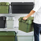 A man putting a green home storage box on the well organised shelf that full of other boxes